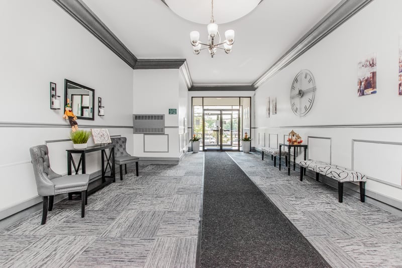 Lobby featuring ornamental molding and wainscoting