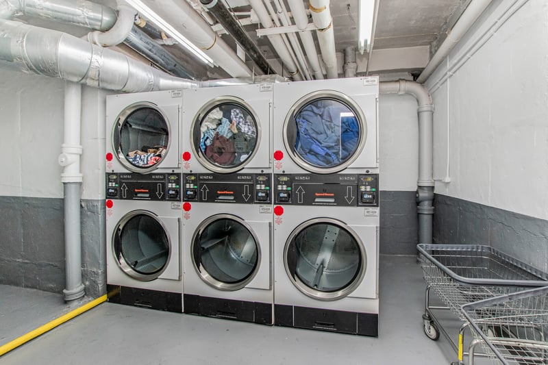Shared laundry featuring stacked washer and clothes dryer and washing machine and dryer