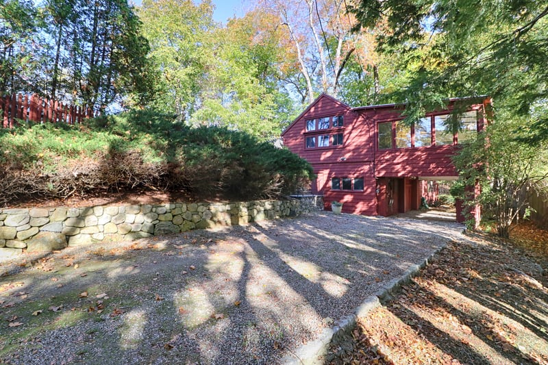 The long shared stone driveway leads to the carport, and stairs to the main entry. Or go inside from the carport.