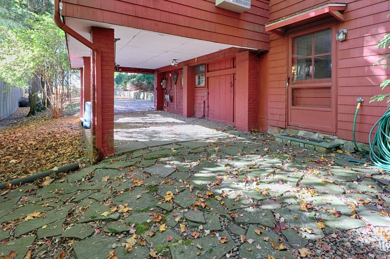 The carport and part of a patio. One car easily, possibly two could park in this part of the driveway.