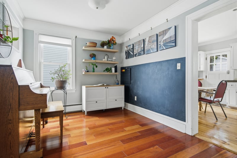 Living area featuring crown molding, light wood-style flooring, and a baseboard radiator