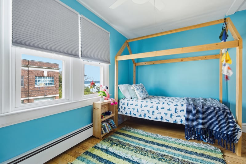 Bedroom featuring a baseboard radiator, light wood-type flooring, and a ceiling fan