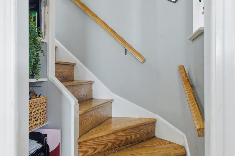 Full bathroom with curtained shower, tile walls, a baseboard heating unit, healthy amount of natural light, and tile patterned flooring