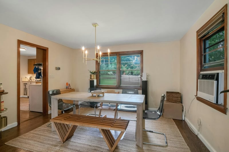 Dining space with dark wood-style flooring, a chandelier, and cooling unit