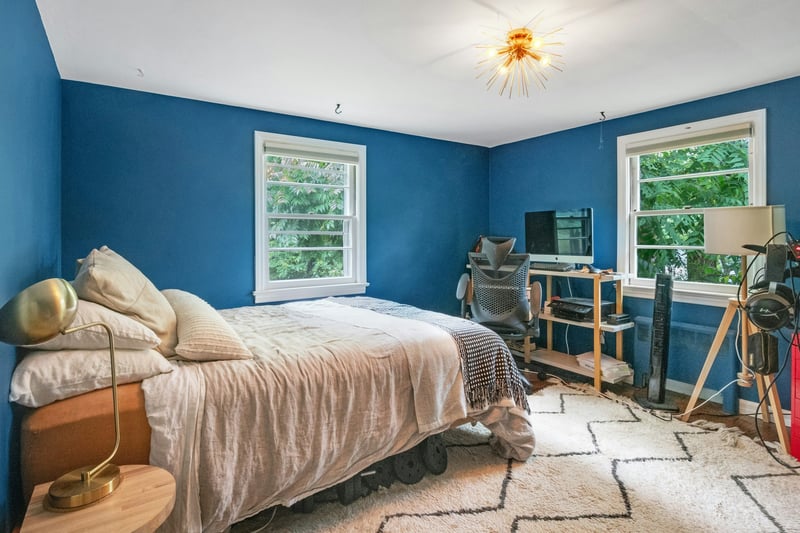 Bedroom with multiple windows and wood finished floors