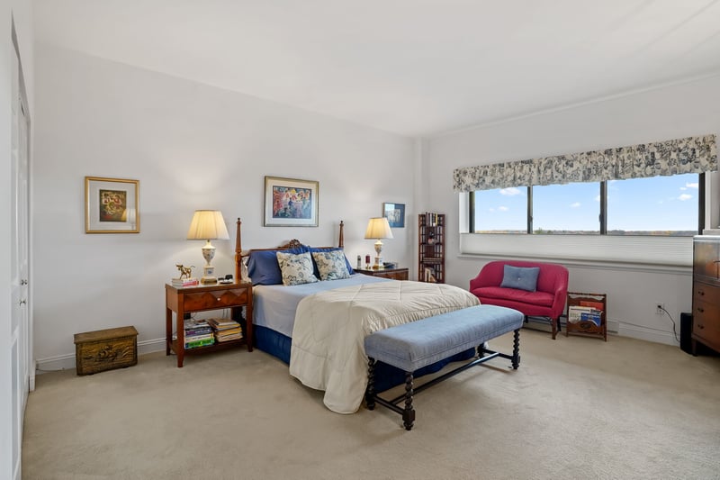 Tremendous primary suite with 9+ foot ceiling, three closets including a walk-in and wall to wall carpet.