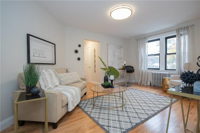 Living room featuring radiator heating unit and wood-type flooring