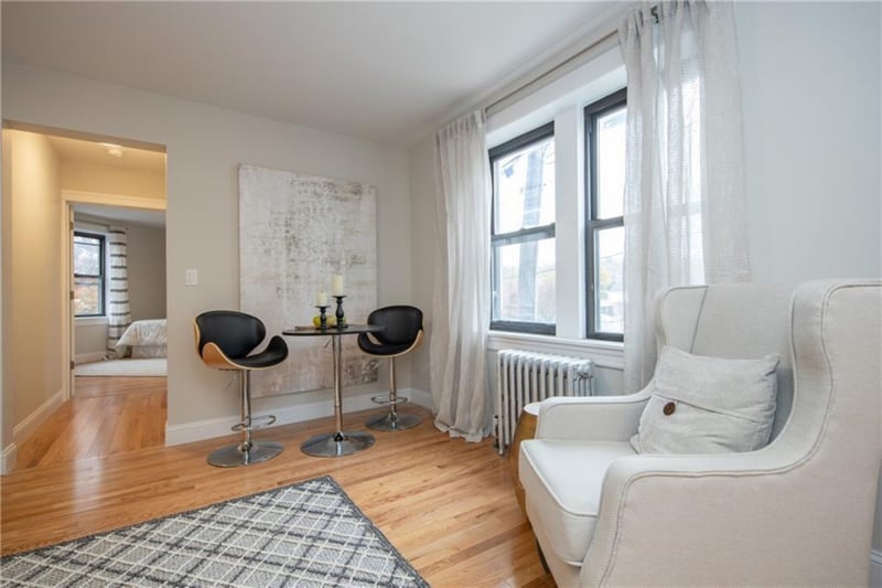 Living area featuring radiator heating unit and hardwood / wood-style flooring