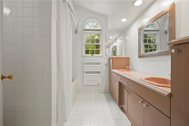 Full bathroom featuring double vanity, shower / bath combo with shower curtain, light tile patterned floors, and recessed lighting