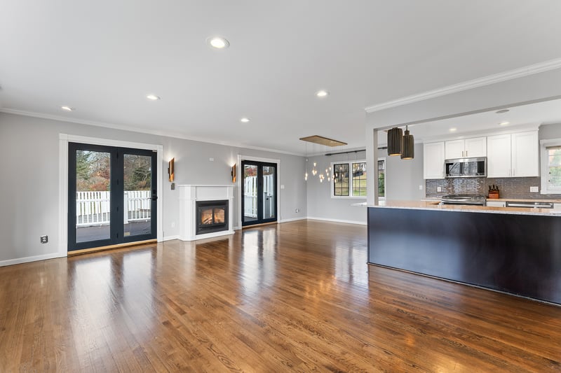 Unfurnished living room with ornamental molding, dark wood-style flooring, recessed lighting, and a glass covered fireplace