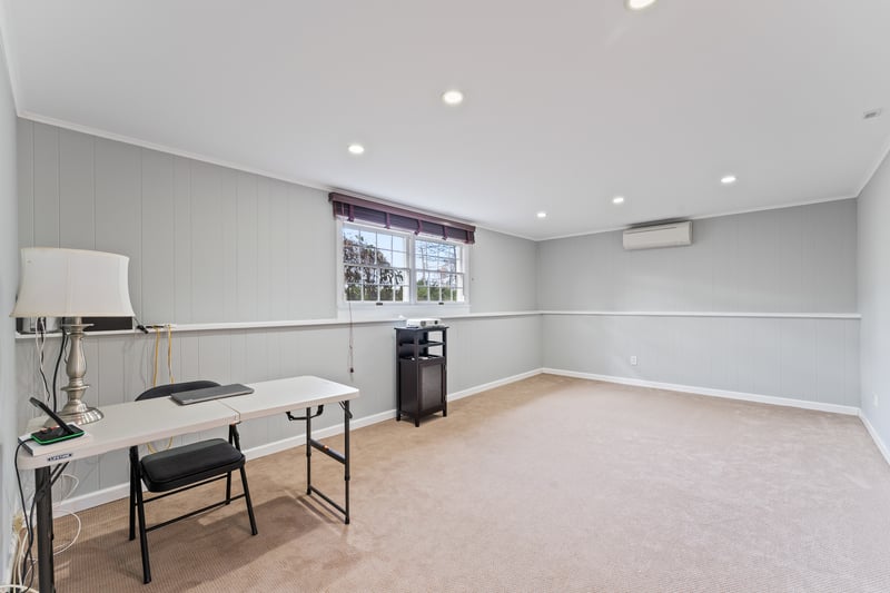 Home office with recessed lighting, crown molding, light colored carpet, wooden walls, and a wall unit AC