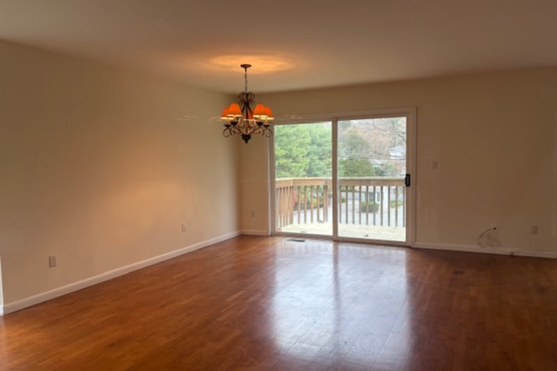 Bright dining area with hardwood floors and access to the deck