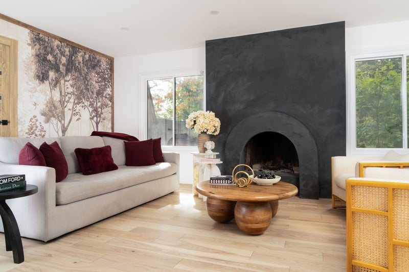 Living room with light wood finished floors and a large fireplace