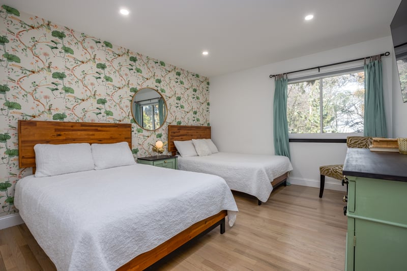 Bedroom featuring wallpapered walls, recessed lighting, light wood finished floors, and an accent wall
