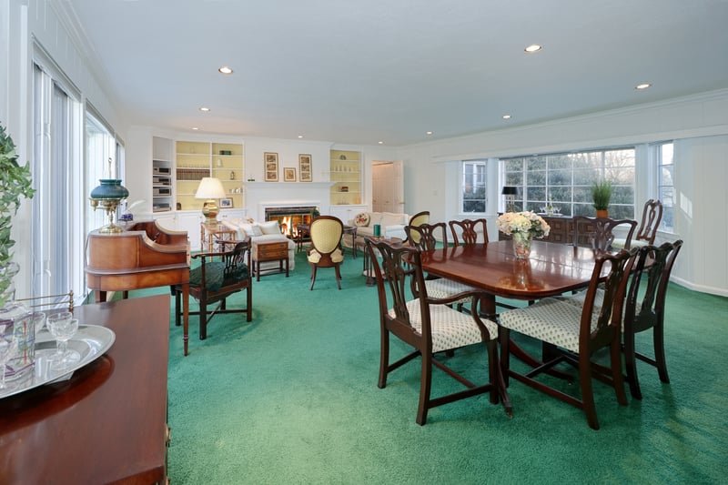 Great room has hardwood floor under carpet.