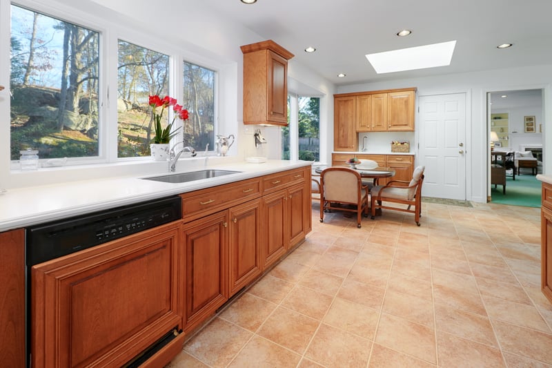 Kitchen view into great room and access to rear patio, laundry, and basement.