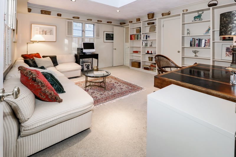 Third bedroom suite is located off the foyer and has been configured as a library with a wall of bookshelves.