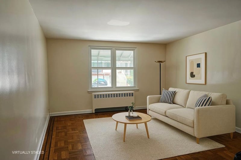Living area featuring radiator and baseboards
