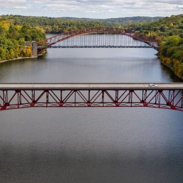 Drone shot of Taconic State Parkway over the New Croton Reservoir between greenery landscapes - stock photo